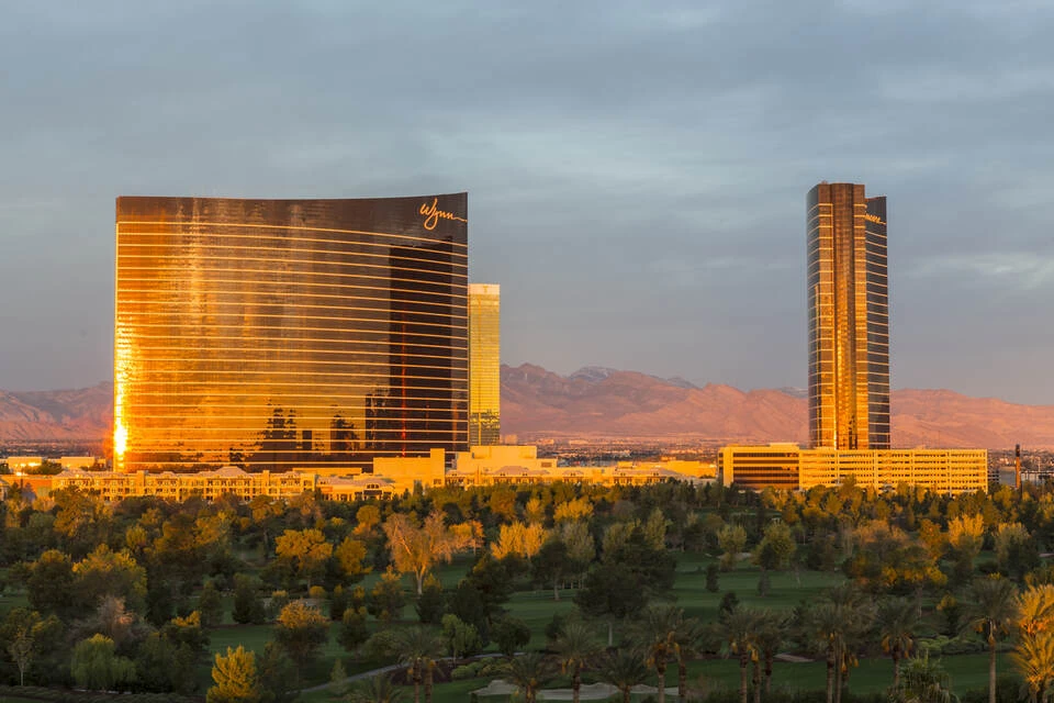 Wynn Casino hotel against a foreground of trees