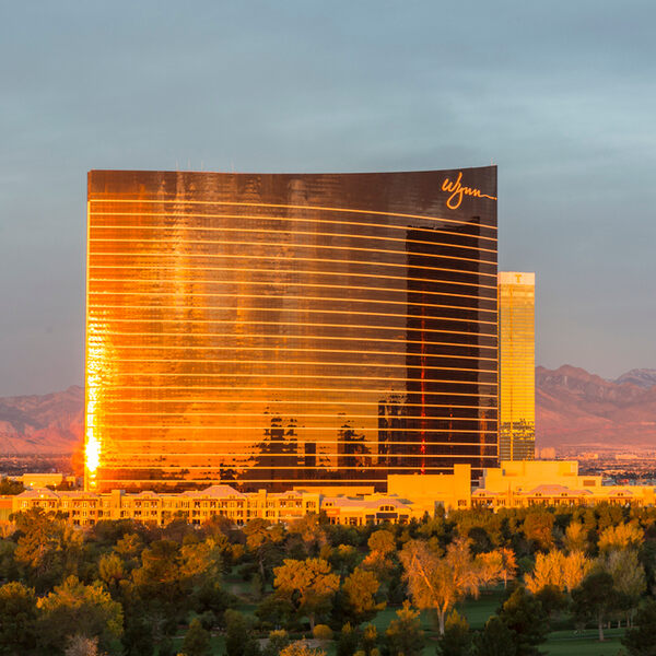 Wynn Casino hotel against a foreground of trees