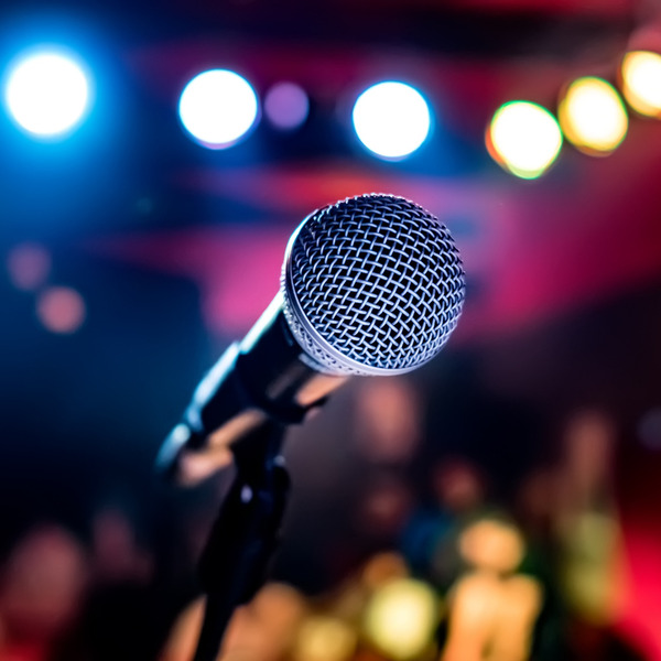 Microphone on stage against a background of auditorium.